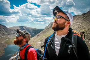 Men exploring with colorful, reef safe SPF sunscreen on their nose